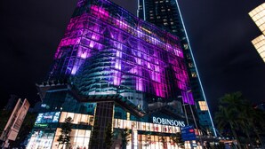 A modern building with a glass facade and illuminated signage. - Expressionz Suites KLCC by Like Home (Kuala Lumpur)