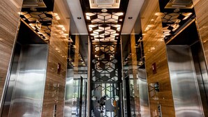 A modern elevator lobby with geometric patterned lighting and metallic elevator doors. - Expressionz Suites KLCC by Like Home (Kuala Lumpur)