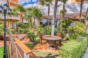Relax in a serene outdoor space surrounded by lush greenery and enjoy the view from the balcony.