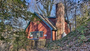 A rustic cabin with a steep roof, a chimney, and a wooden fence. - 'Nature's Retreat' w/ Hot Tub: 7 Mi to Bryson City (Whittier)