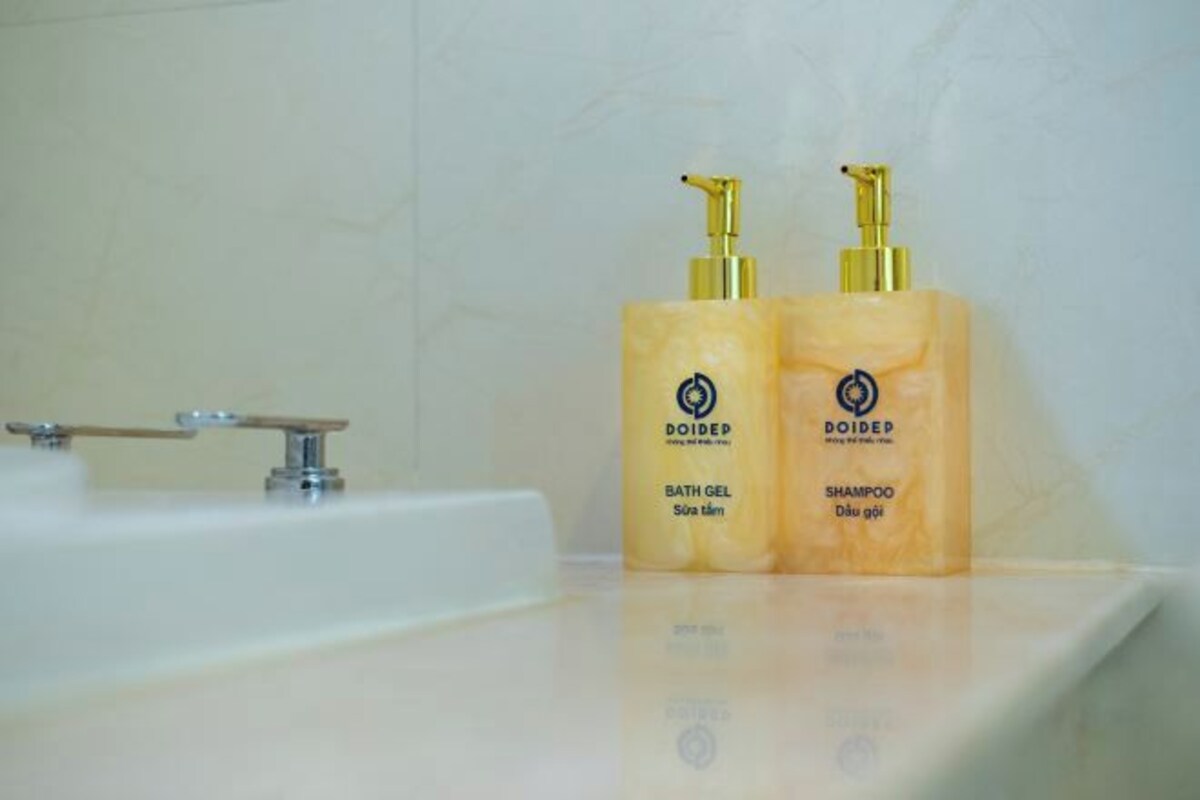 Two bottles of DOIDEP bath gel and shampoo on a bathroom counter.