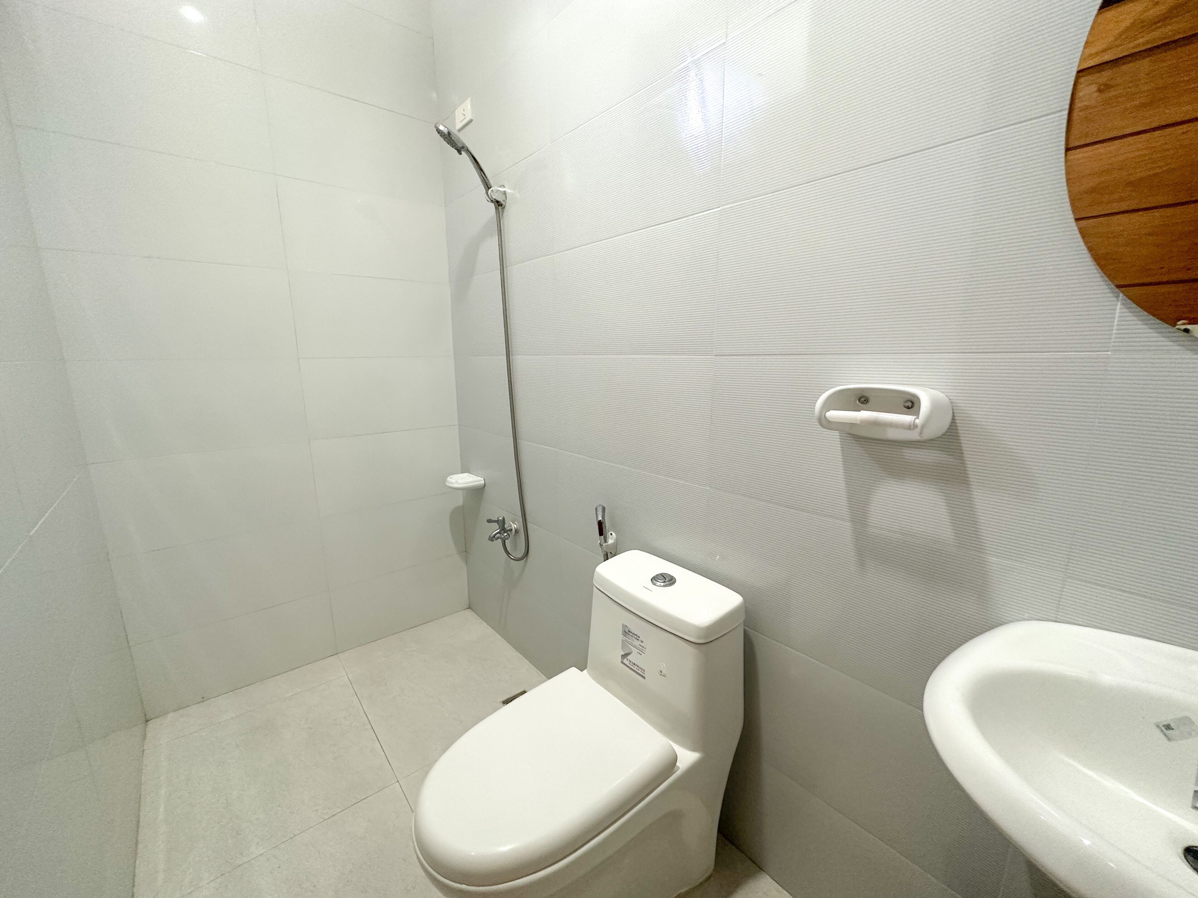 A small, modern bathroom with a toilet, bidet, and sink.