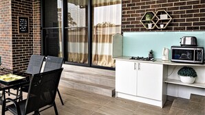A modern kitchen with a microwave, toaster, and coffee maker on the counter.