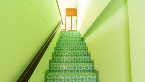 A staircase with green patterned steps leading to a door at the top. - Khum Suk Resort (Hat Yai)