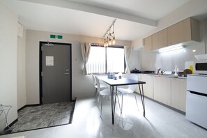 Enjoy meals in the kitchen and dining area, featuring a dining table and chairs, a refrigerator, and microwave.