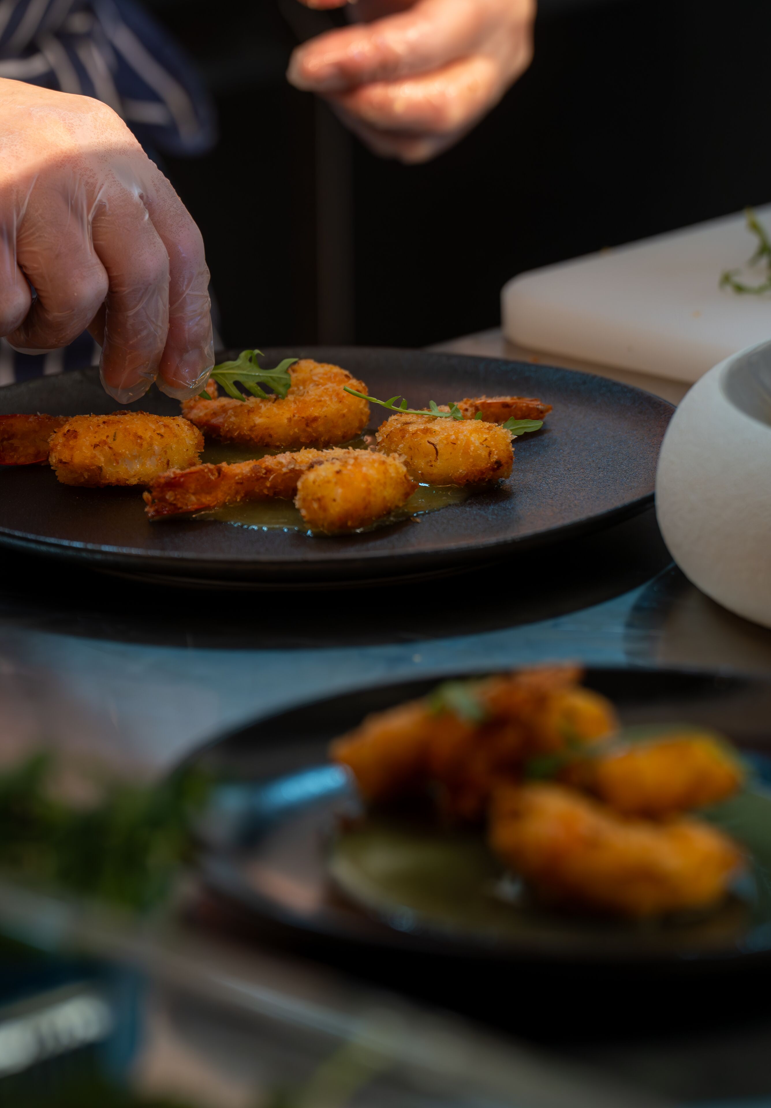 A person serving food on a plate.