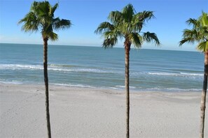 Enjoy a serene beach experience with gentle waves lapping at the shore.