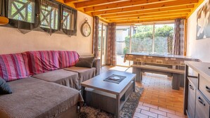 Una sala de estar acogedora con sofá, mesa de centro y mesa de billar.