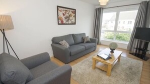 Appartement | Woonkamer | Een flatscreentelevisie