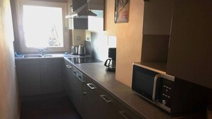 A compact kitchen with a microwave, kettle, and coffee maker. - MEGEVE-T2-44M²-NEAR TOWN CENTER (Megève)