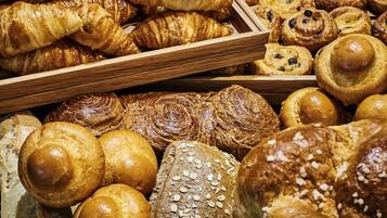 A variety of baked goods including croissants, bread rolls, and pastries.