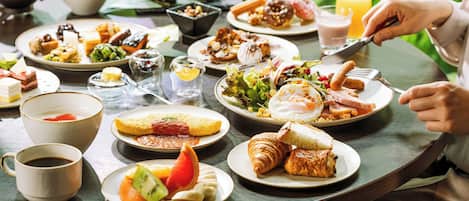 A breakfast table with various dishes, including eggs, toast, and fruit.