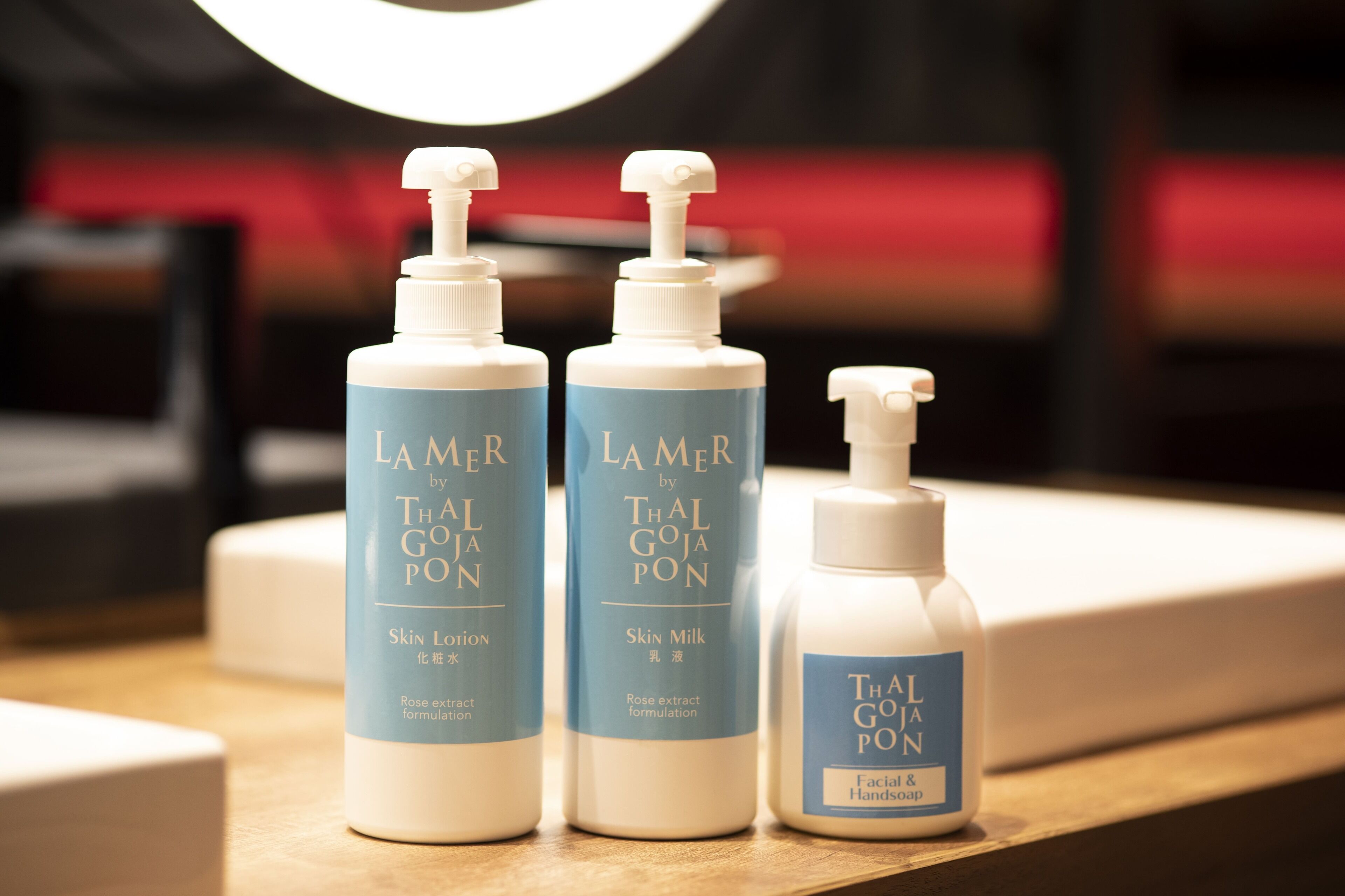 Three bottles of La Mer by Thal Goja Pon skincare products on a counter.