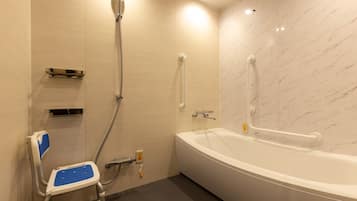 A bathroom with a white bathtub, a shower with a handheld showerhead, a grab bar, and a wheelchair-accessible seat.