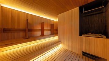 A sauna with wooden benches and a bench with a backrest.
