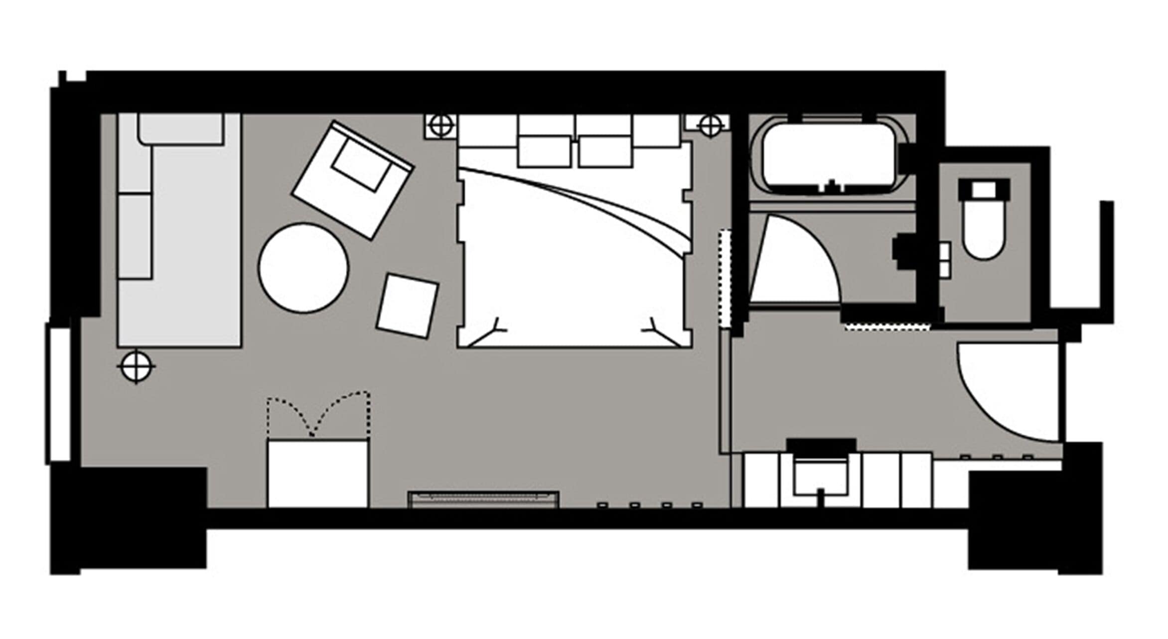 A hotel room layout with a bed, seating area, bathroom, and kitchenette.