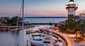 A marina with boats docked, a lighthouse, and a building labeled 'ULTRA'.