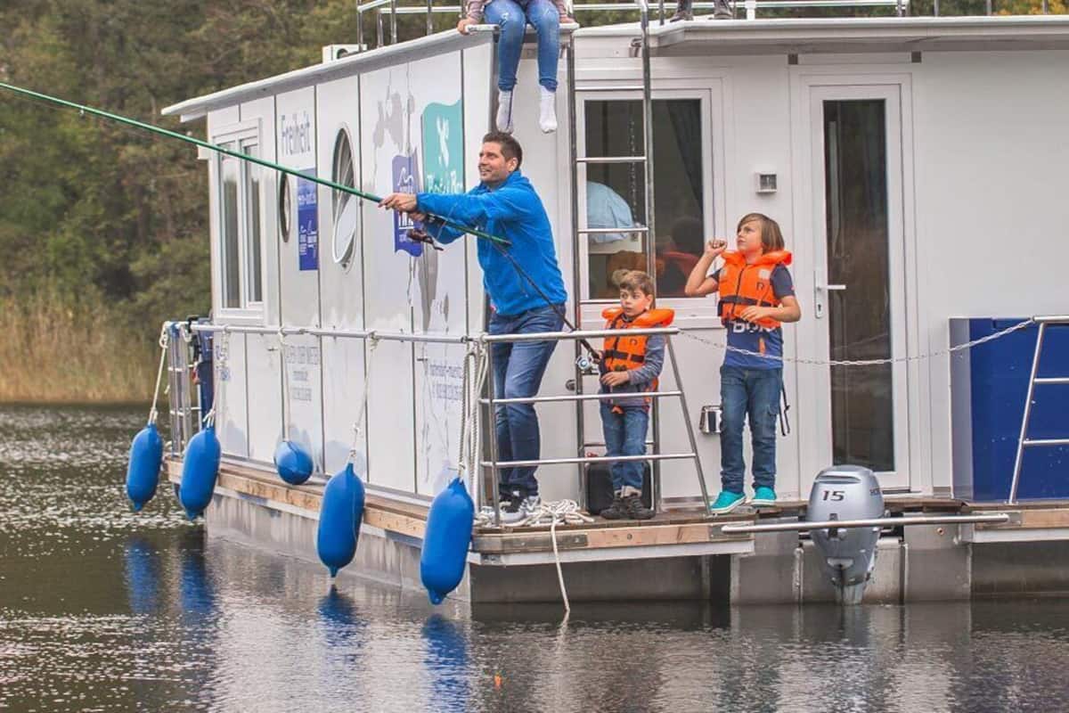 A floating structure with a dock, a ladder, and a person fishing.
