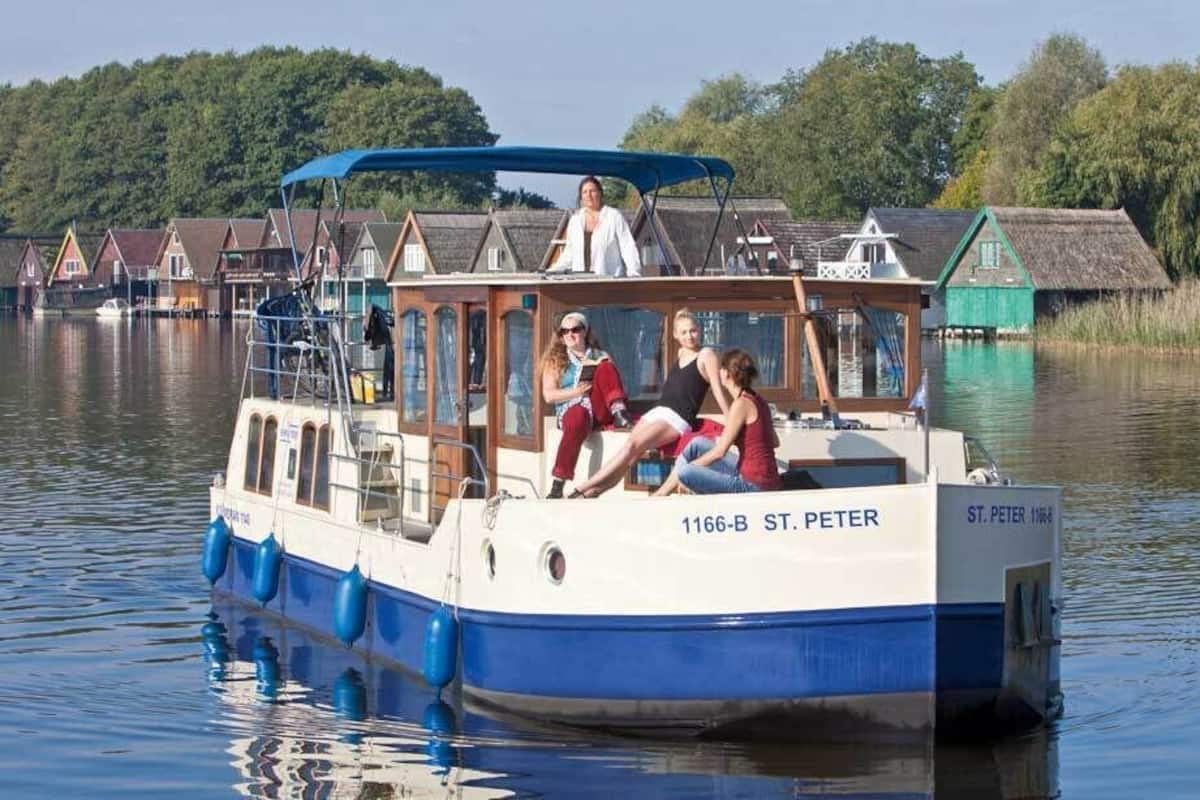 A boat with the name "ST. PETER" docked at a pier.