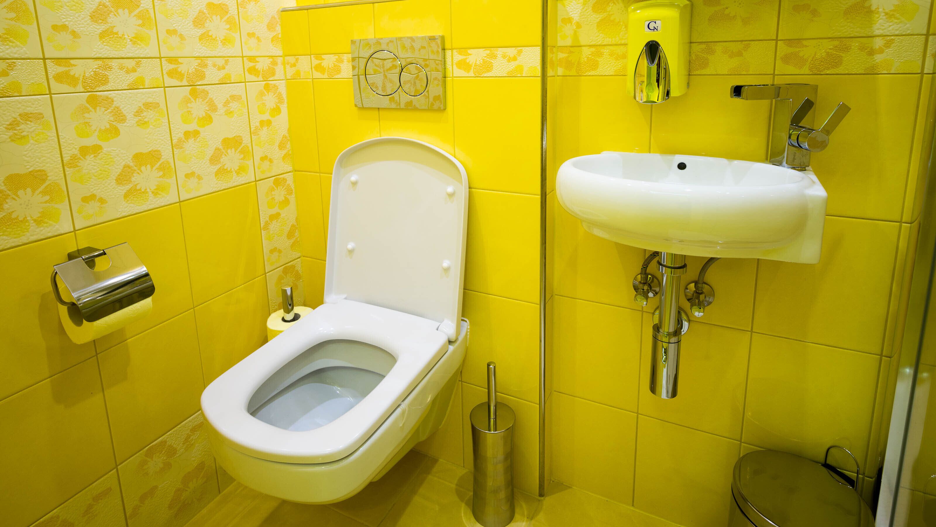 A bathroom with a toilet, bidet, and sink.