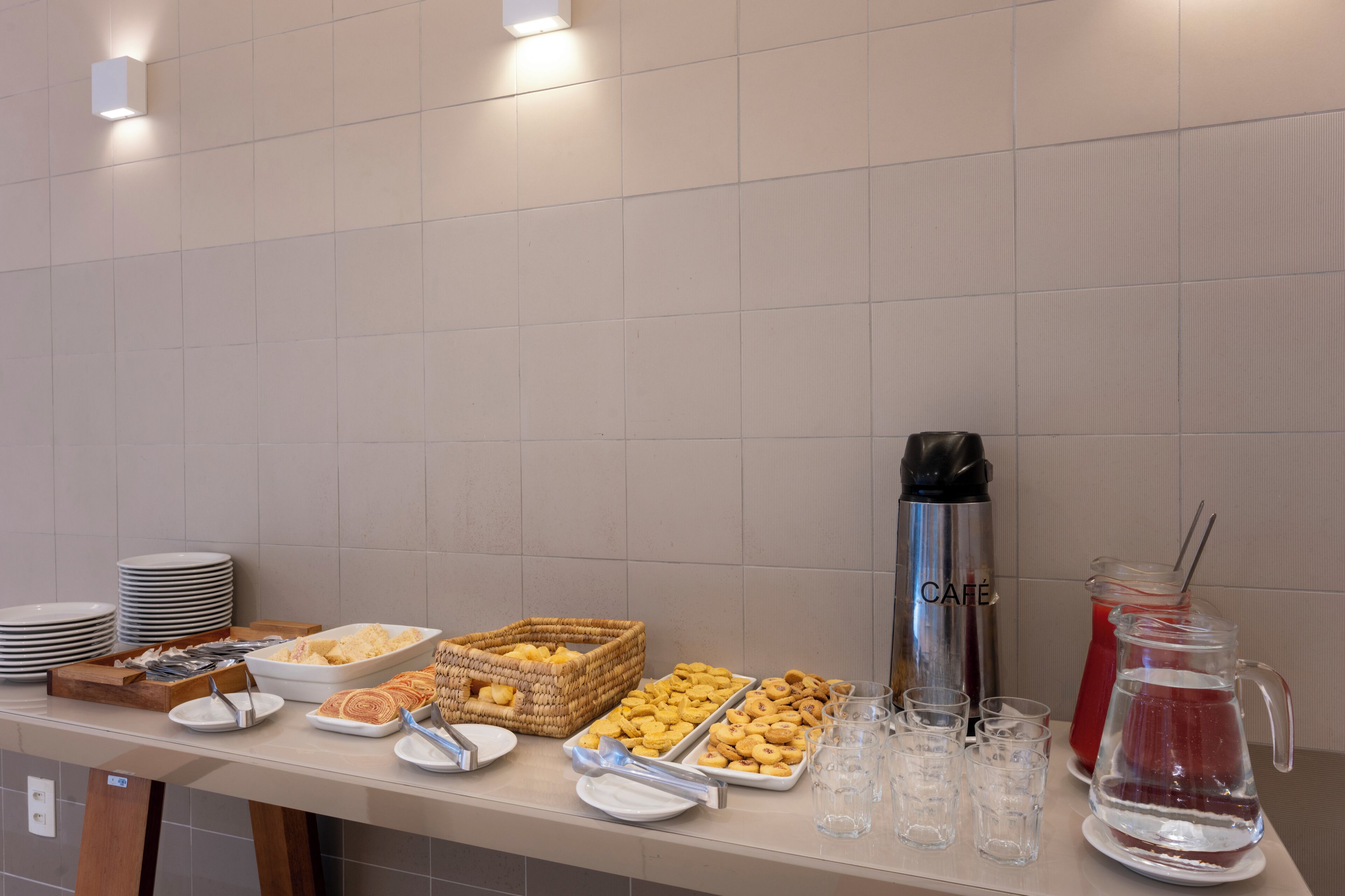 A buffet table with various food items and beverages.
