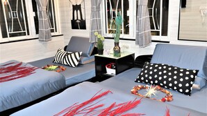 A modern living room with a sofa set, a coffee table, and decorative pillows. - Metrocity Lounge (Kowloon)