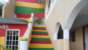 A staircase with colorful steps leading to an upper level. - Solet's Paradise Negril (Negril)