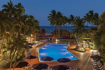 Outdoor pool, open 7:00 AM to 8:00 PM, pool umbrellas, sun loungers at Radisson Resort Miami Beach 