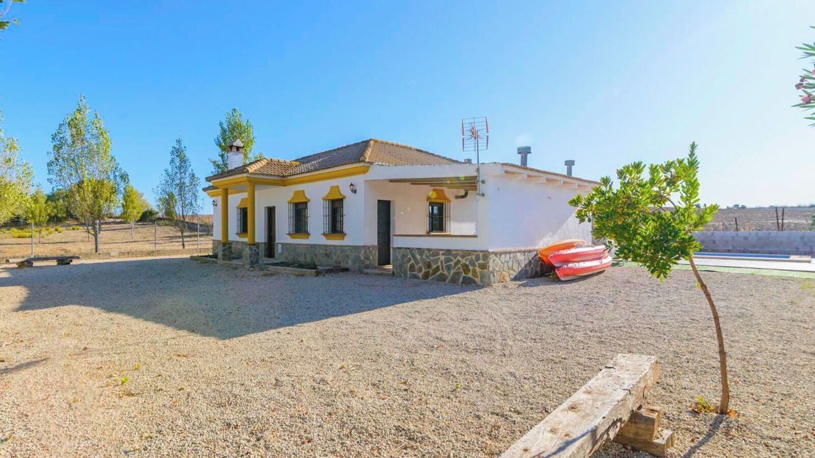 Un edificio de una sola planta con base de piedra y techo de tejas.