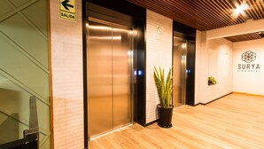 An elevator with a 'SALIDA' sign, a potted plant, and a 'SURYA LIMA HOTEL' sign. - Surya Lima (Lima)