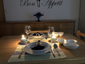 Enjoy a romantic dinner for two at this intimate dining setting, complete with a beautifully set table and elegant ambiance.