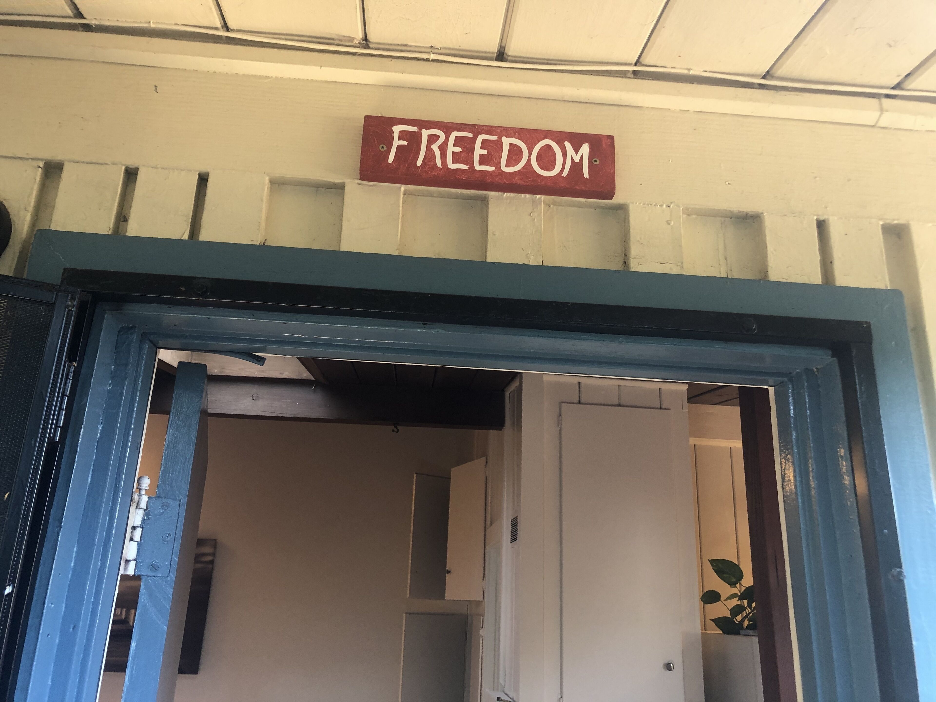 A doorway with a sign that reads "FREEDOM" above it.