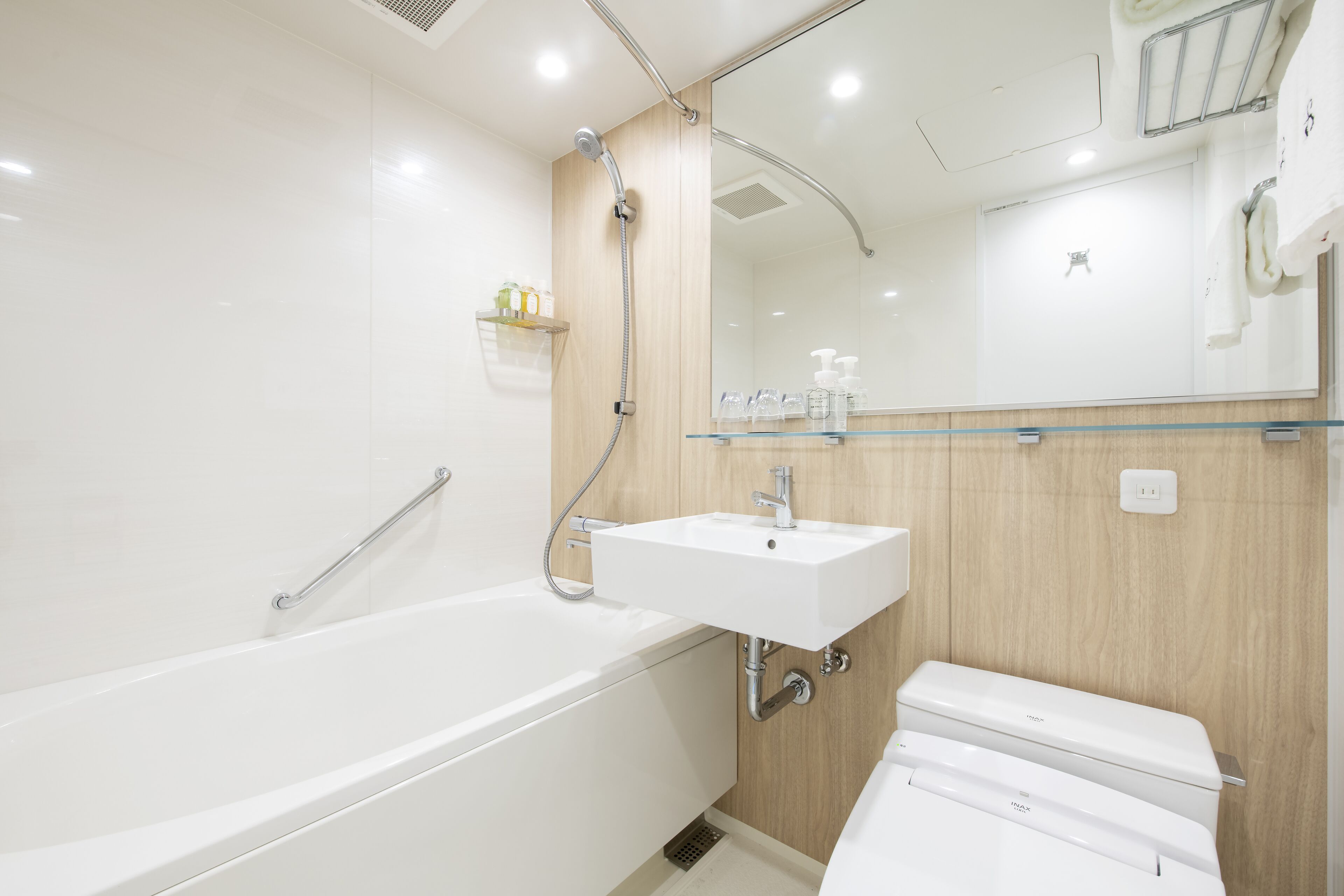 A modern bathroom with a bathtub, a sink, and a toilet.