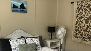 A neatly made bed with white linens and two towels folded on top. - Mohaka River Farm - Campsite (Te Haroto)