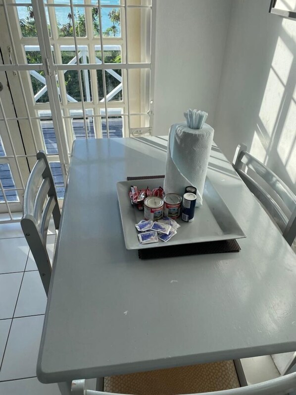 A table with a towel, toiletries, and a tray with cards.
