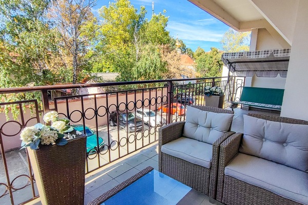 Large terrace overlooking a park with an old Orthodox churche