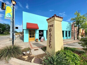 A building with a blue facade, a red awning, and a sign reading 'THE PASO.'