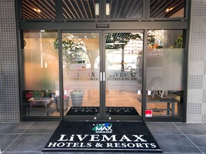 The entrance to Livemax Hotels & Resorts with a clear view of the parking area and a sign indicating the hotel name. - Hotel Livemax Fukushima Koriyama Ekimae (Koriyama)