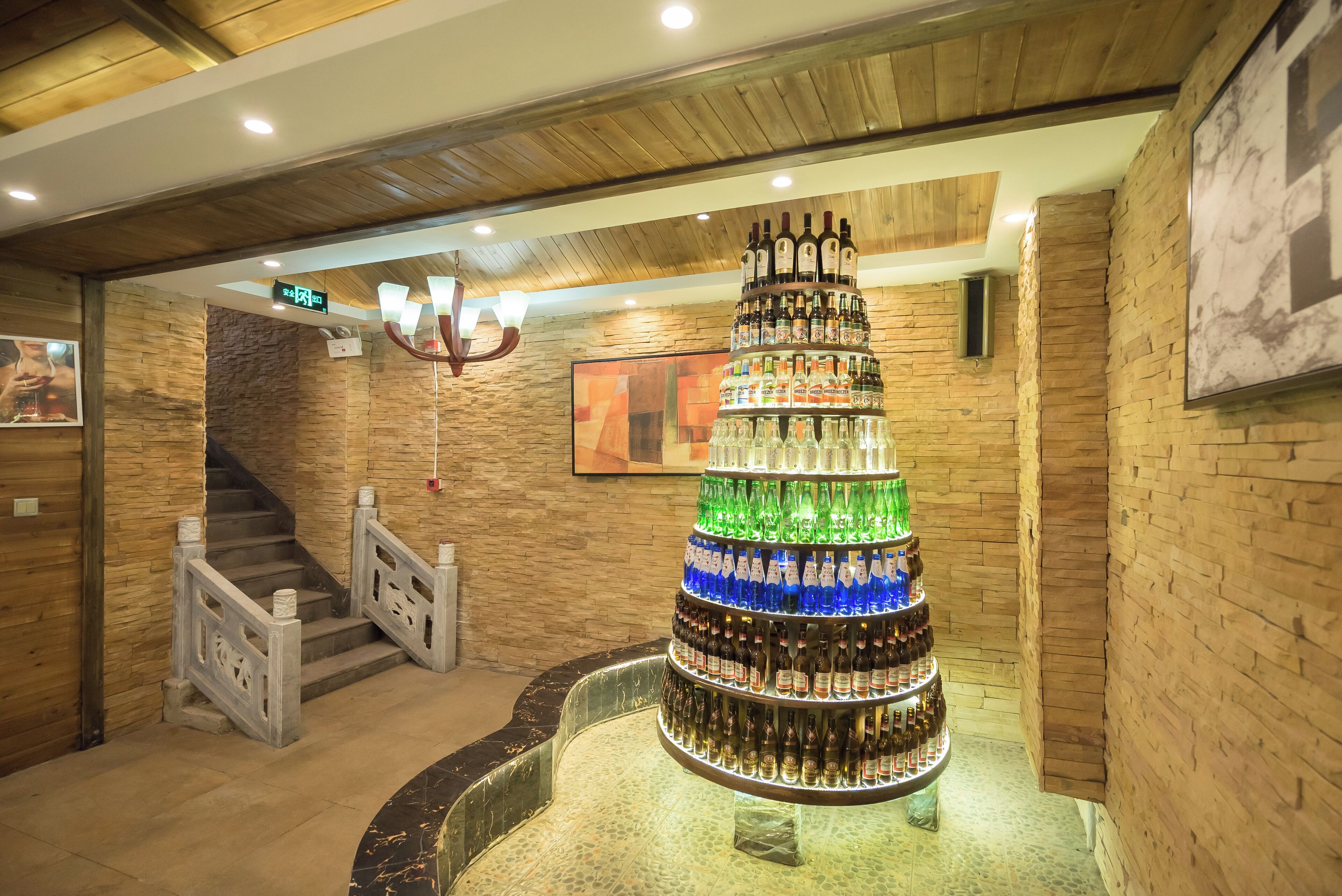 A bar area with a large, tiered display of bottles and glasses.
