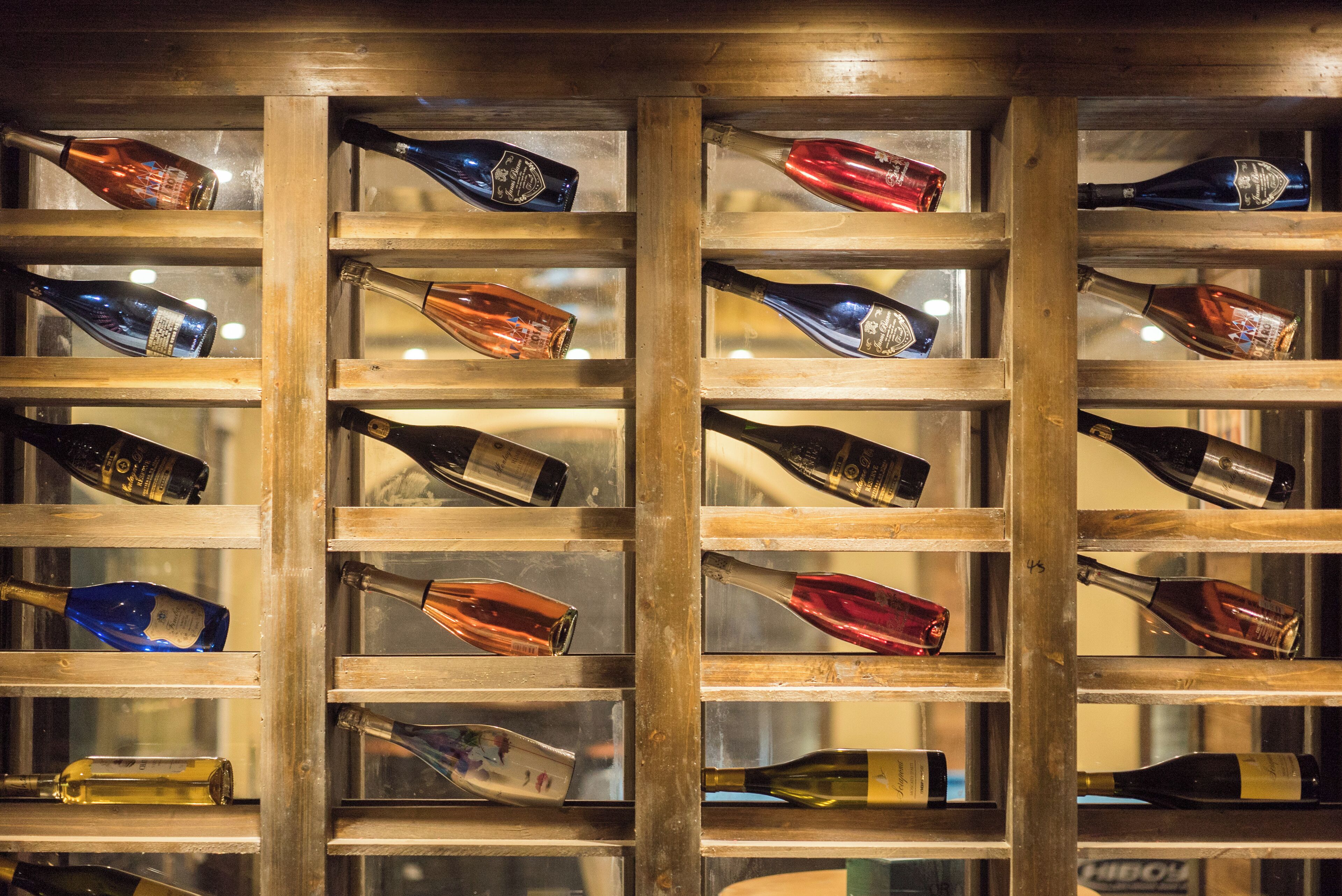 Una estantería para vinos con varias botellas.