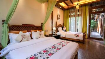 A double room with two beds, a wooden headboard, a nightstand, a lamp, and a window with curtains.