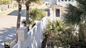 A two-story building with a stone facade and multiple windows. - Summer & July 4th Savings at Beachside Colony Tybee's ONLY Oceanfront Resort 3/2 (Tybee Island)