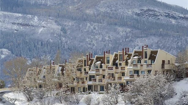A multi-story hotel with a modern architectural design, situated in a snowy mountainous area. - Storm Watch Condominiums - Sw205 (Steamboat Springs)