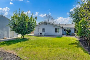 A single-story house with a front yard, a small patio with a table and chairs, and a garage. - ⭐️offering the Lowest Rate (2000 sqf)-KingBed, Pool Table, 55” Smart TV (Ontario)