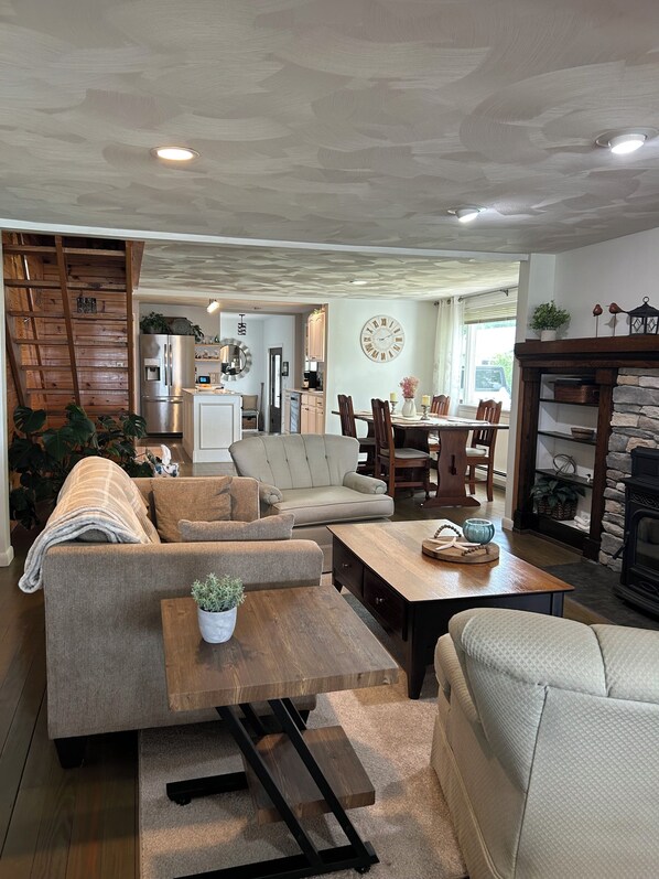 A spacious living room with a sofa, coffee table, and a fireplace.