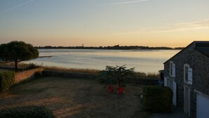A view of a beach with a building in the foreground.