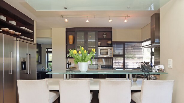 A modern kitchen with a central island, bar stools, and a built-in microwave. - Vacation Villa 2WW (Cape Town)