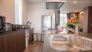 A modern kitchen with stainless steel appliances, a large sink, and a window providing natural light. - Onnason vacation rental N (Onna)