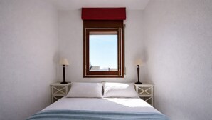 A narrow room with a bed, two bedside tables with lamps, a window with a red blind, and a view of buildings outside. - 337-Nice apartment with view on the marina (Empuriabrava)