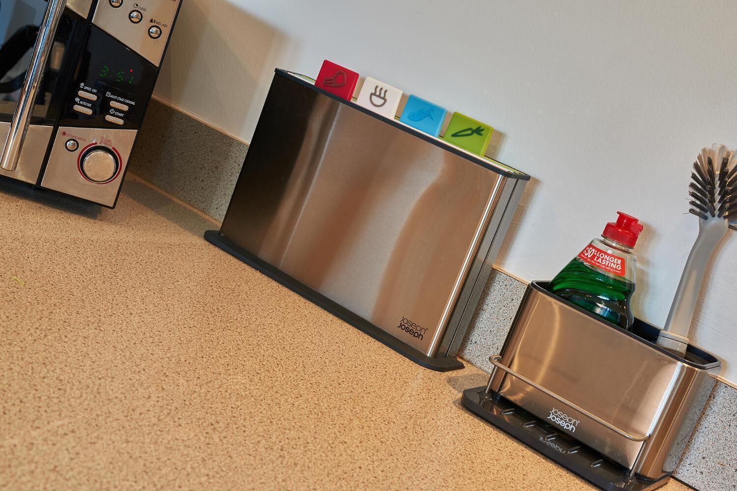 A kitchen with a stainless steel microwave, a toaster, and a coffee maker.